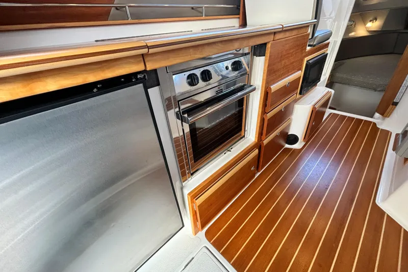  Yacht Photos Pics Interior of 2021 Cutwater C-32 CB with wood flooring and stainless steel appliances.