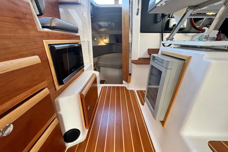  Yacht Photos Pics Interior of 2021 Cutwater C-32 CB yacht with wood flooring and microwave.