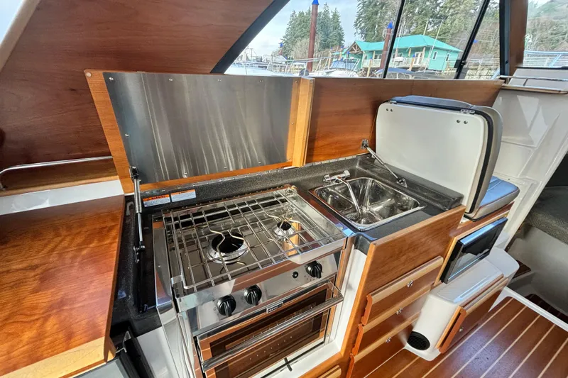  Yacht Photos Pics 2021 Cutwater C-32 CB boat kitchen with stove and sink.