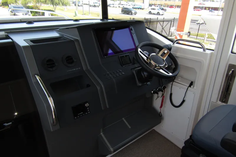 Yacht Photos Pics Interior cockpit of 2025 Nimbus Commuter 11 with modern steering and control panel.