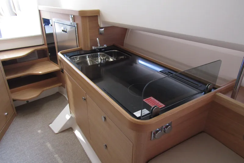  Yacht Photos Pics Modern kitchen area in 2025 Nimbus Commuter 11 boat, featuring sink and stove.