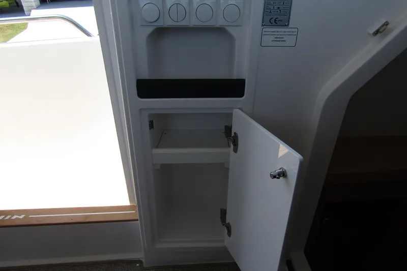  Yacht Photos Pics Open storage compartment inside a 2025 Nimbus Commuter 11 boat.