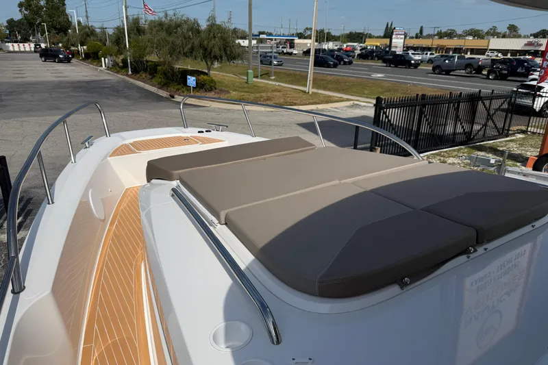  Yacht Photos Pics Nimbus Commuter 11 (2025) boat with cushioned deck, parked near a road.