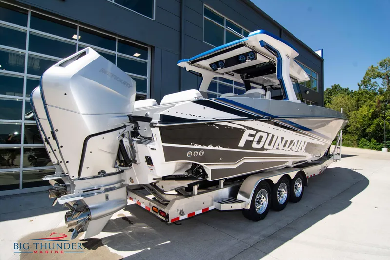  Yacht Photos Pics 2024 Fountain 38 SCX boat on a trailer outside a modern building.