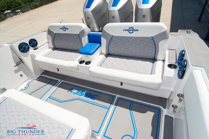  Yacht Photos Pics 2024 Fountain 38 SCX boat interior with cushioned seating and triple outboard engines.