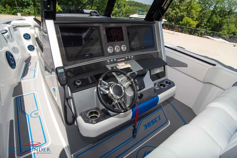  Yacht Photos Pics 2024 Fountain 38 SCX boat cockpit with advanced navigation system and steering wheel.