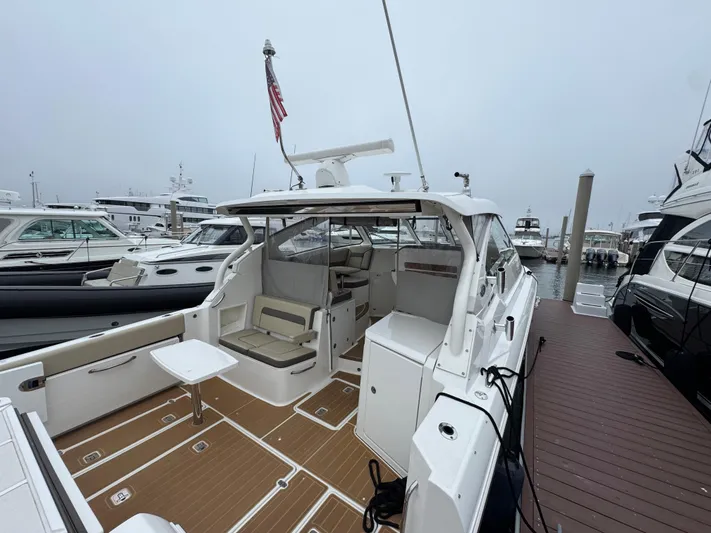  Yacht Photos Pics 2019 Pursuit DC 365 Dual Console boat docked, featuring spacious seating and sleek design.