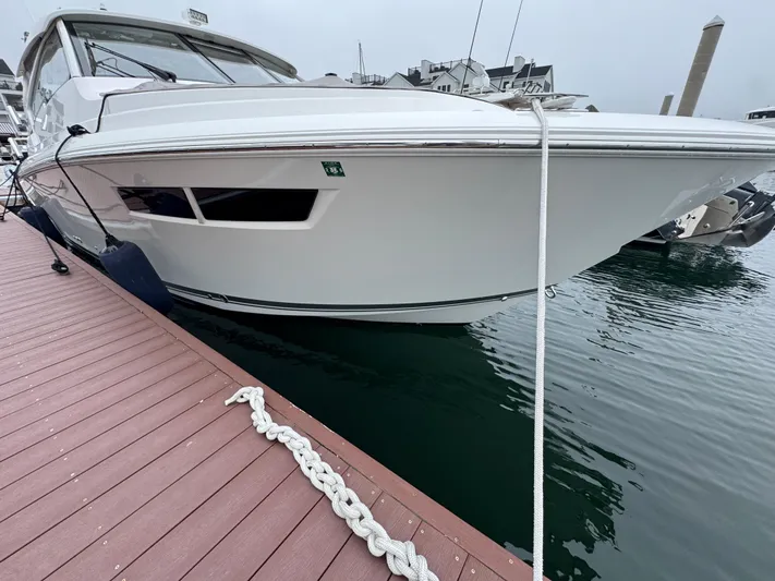  Yacht Photos Pics 2019 Pursuit DC 365 Dual Console boat docked at marina, side view.