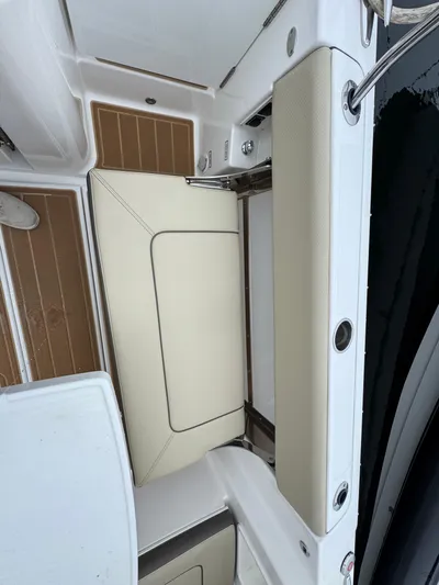  Yacht Photos Pics 2019 Pursuit DC 365 Dual Console boat interior with beige seating and teak flooring.