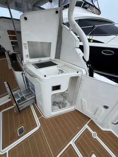  Yacht Photos Pics 2019 Pursuit DC 365 Dual Console boat with open storage and sink on deck.