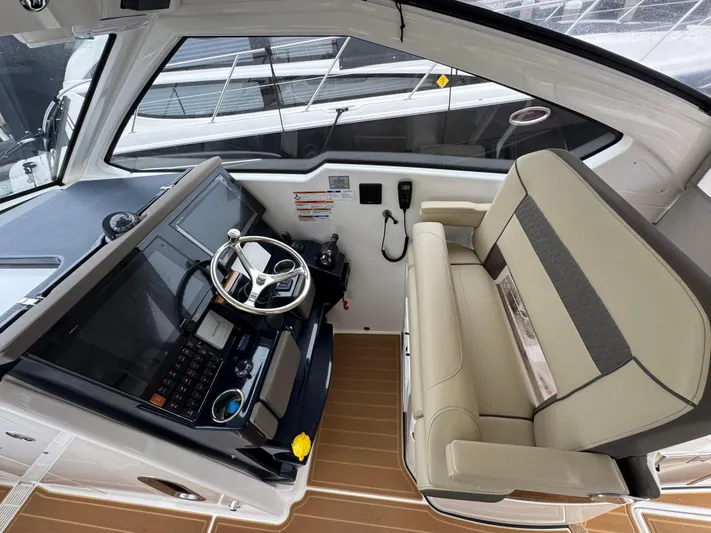  Yacht Photos Pics 2019 Pursuit DC 365 Dual Console boat interior with steering wheel and seating area.