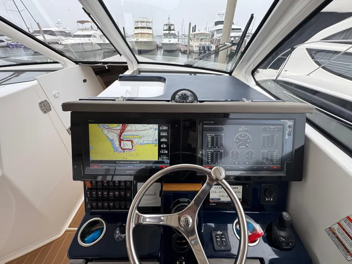  Yacht Photos Pics 2019 Pursuit DC 365 Dual Console helm with navigation screens and steering wheel.