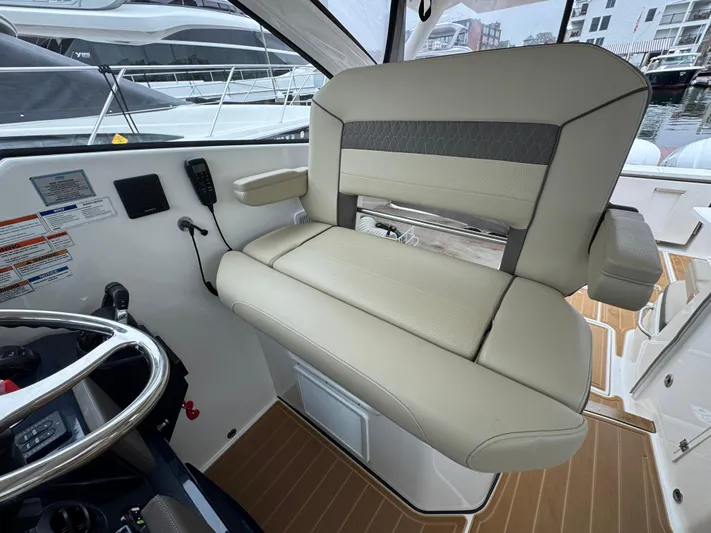  Yacht Photos Pics 2019 Pursuit DC 365 Dual Console boat interior with beige seating and control panel.