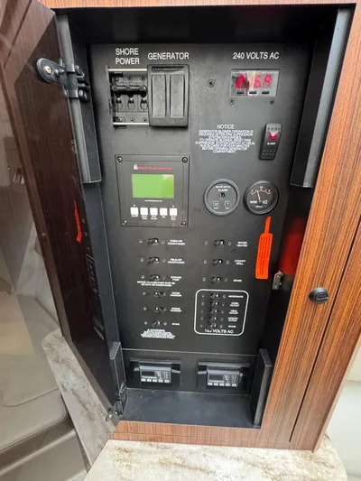  Yacht Photos Pics Electrical panel of 2019 Pursuit DC 365 Dual Console boat, showing shore power and generator controls.