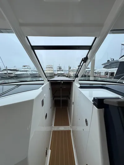  Yacht Photos Pics 2019 Pursuit DC 365 Dual Console boat interior with marina view.