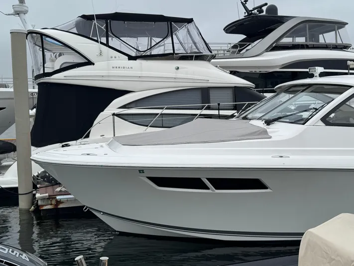  Yacht Photos Pics 2019 Pursuit DC 365 Dual Console boat docked alongside other luxury yachts.