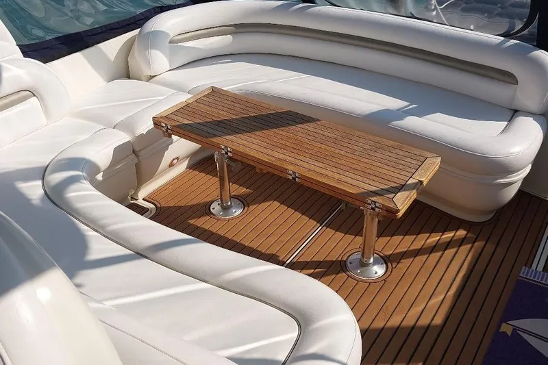 Cavok Yacht Photos Pics Luxurious seating area on 2004 Sea Ray 420 Sundancer yacht with wooden table.