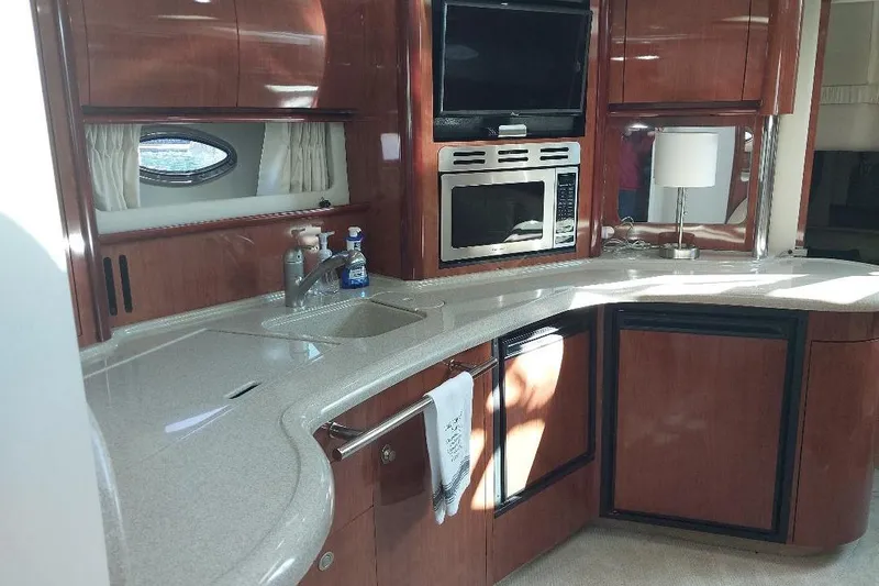 Cavok Yacht Photos Pics Luxurious 2004 Sea Ray 420 Sundancer yacht kitchen with modern amenities and sleek design.