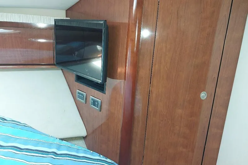 Cavok Yacht Photos Pics Interior of 2004 Sea Ray 420 Sundancer with TV and wooden paneling.