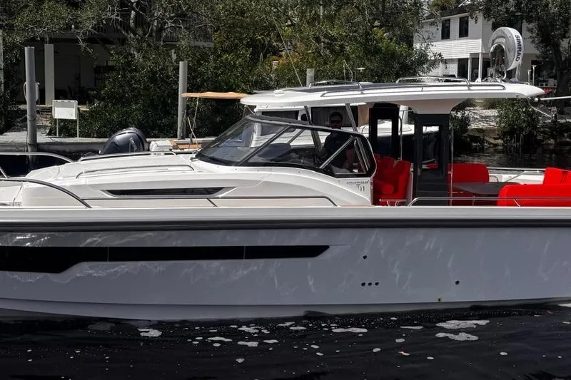  Yacht Photos Pics 2025 Nimbus Tender 11 boat with sleek design and vibrant red seating.