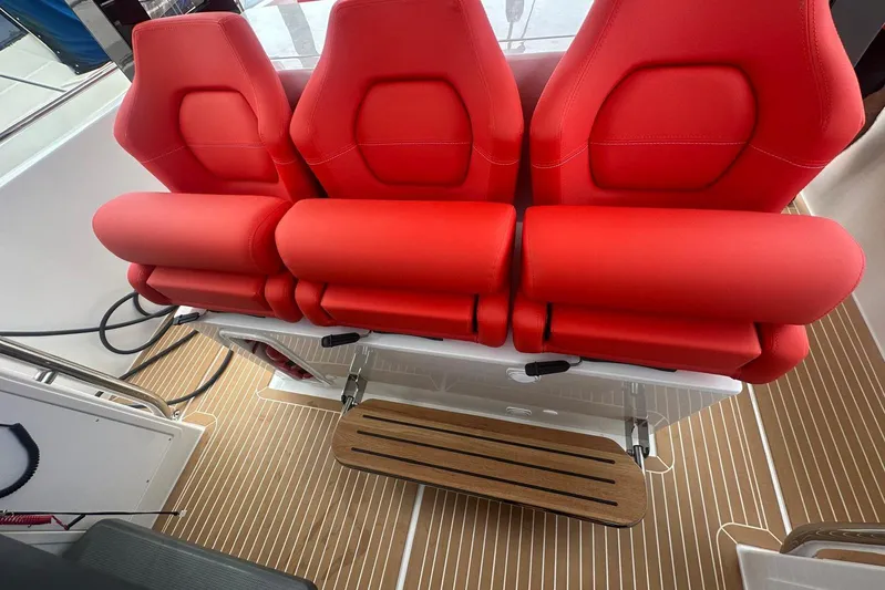  Yacht Photos Pics Red seats on 2025 Nimbus Tender 11 boat with wooden flooring.