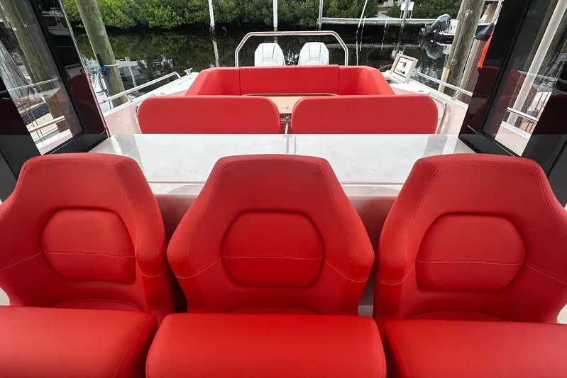  Yacht Photos Pics Red interior seating of 2025 Nimbus Tender 11 boat, featuring modern design.