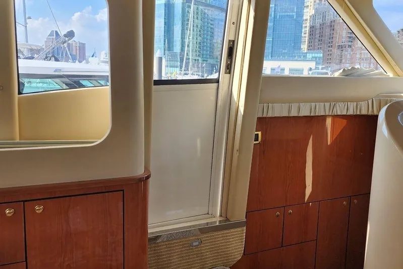  Yacht Photos Pics Interior view of 2001 Sea Ray 540 Cockpit Motor Yacht with cityscape background.