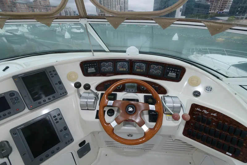  Yacht Photos Pics 2001 Sea Ray 540 Cockpit Motor Yacht helm with advanced navigation controls and wood-accented steering wheel.