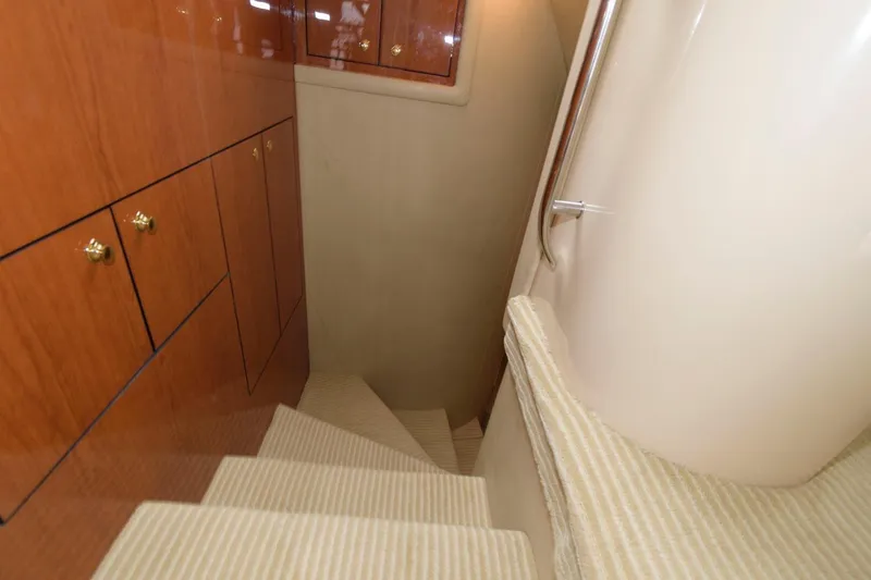  Yacht Photos Pics Staircase inside 2001 Sea Ray 540 Cockpit Motor Yacht with wooden cabinets and carpeted steps.