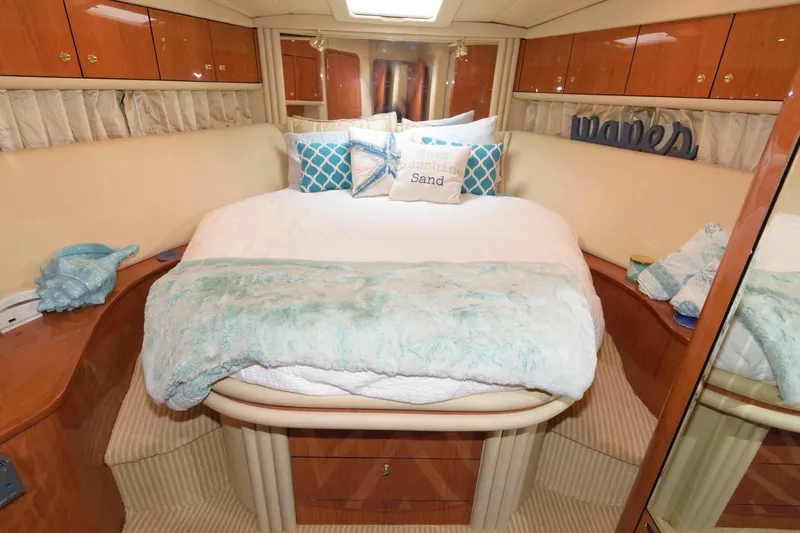  Yacht Photos Pics Luxurious bedroom interior of 2001 Sea Ray 540 Cockpit Motor Yacht with cozy bedding.