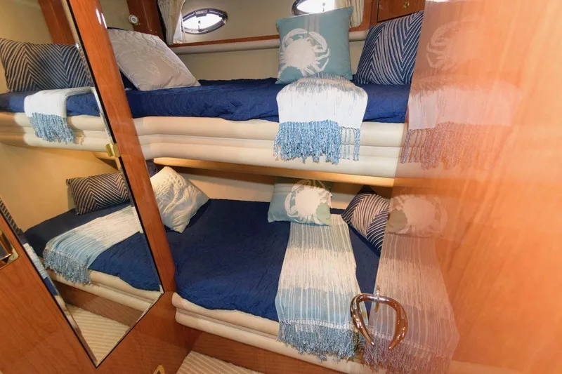  Yacht Photos Pics Bunk beds in 2001 Sea Ray 540 Cockpit Motor Yacht cabin, featuring blue and white decor.