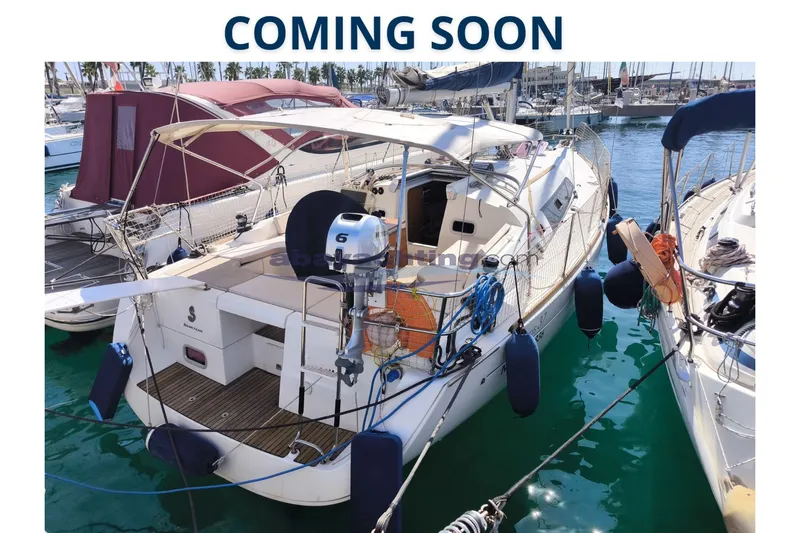  Yacht Photos Pics 2007 Beneteau Oceanis 37 sailboat docked, with protective fenders and outboard motor.