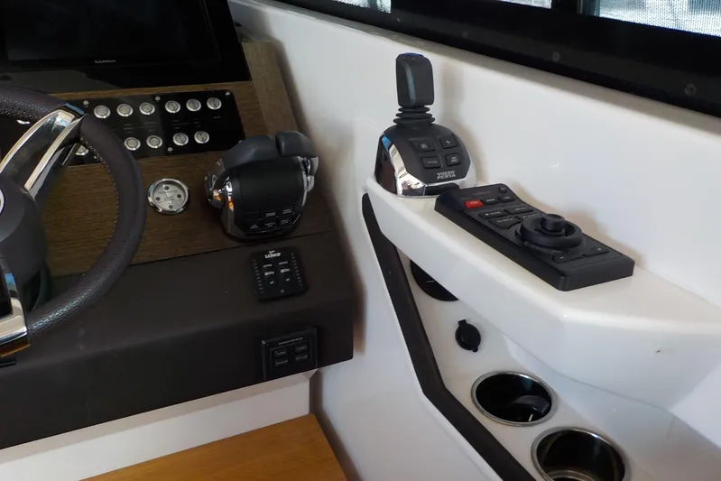"double Dimond" Yacht Photos Pics Control panel of 2018 Tiara Yachts 39 Coupe with steering wheel and joystick controls.