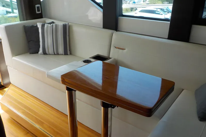 "double Dimond" Yacht Photos Pics Luxurious interior of 2018 Tiara Yachts 39 Coupe with elegant seating and wooden table.