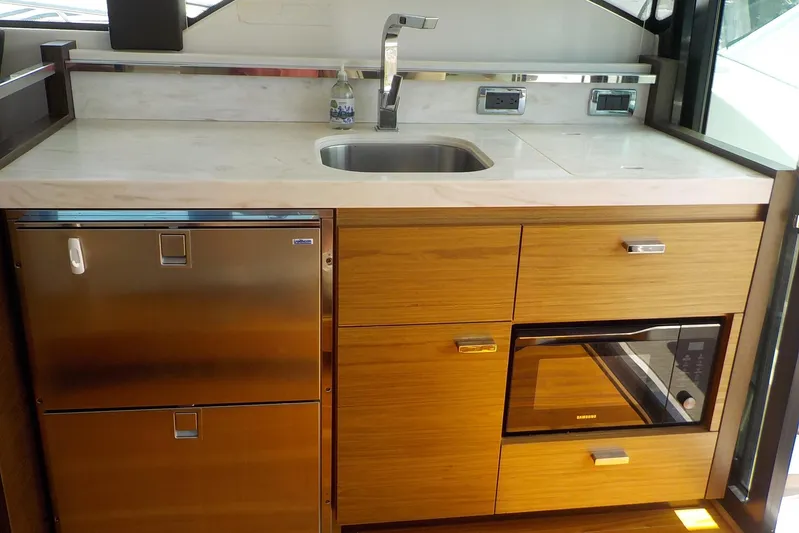 "double Dimond" Yacht Photos Pics Modern kitchen area in 2018 Tiara Yachts 39 Coupe with sink, fridge, and microwave.