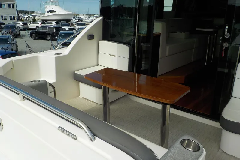 "double Dimond" Yacht Photos Pics 2018 Tiara Yachts 39 Coupe cockpit with seating and wooden table, docked at marina.