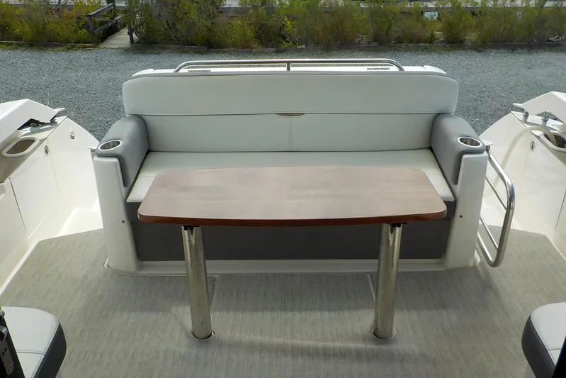 "double Dimond" Yacht Photos Pics 2018 Tiara Yachts 39 Coupe interior with cushioned seating and wooden table.