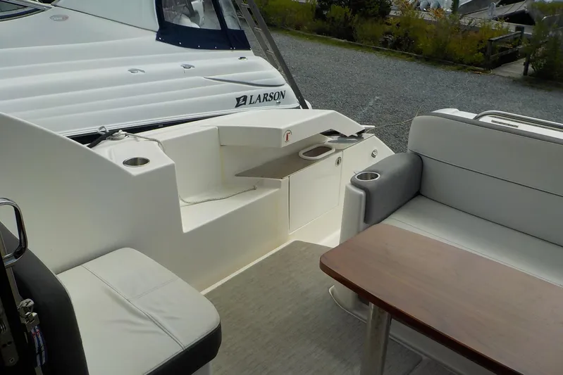 "double Dimond" Yacht Photos Pics 2018 Tiara Yachts 39 Coupe interior with seating and table, docked beside another boat.