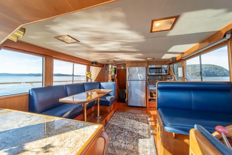 Take Chances Yacht Photos Pics Interior of 1986 Ocean Alexander Cockpit M/Y yacht with blue seating and panoramic windows.