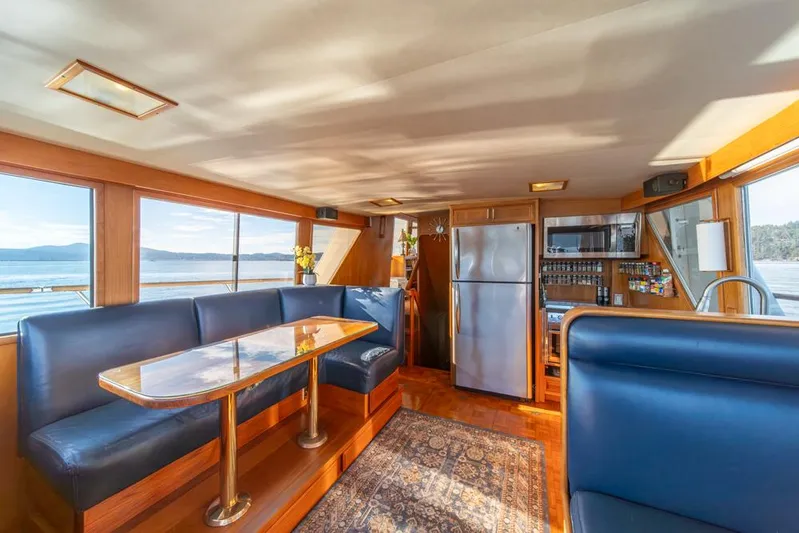 Take Chances Yacht Photos Pics Luxurious 1986 Ocean Alexander Cockpit M/Y interior with dining area and scenic views.