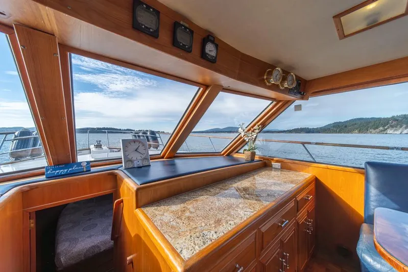 Take Chances Yacht Photos Pics Interior of 1986 Ocean Alexander Cockpit M/Y with scenic ocean view through large windows.