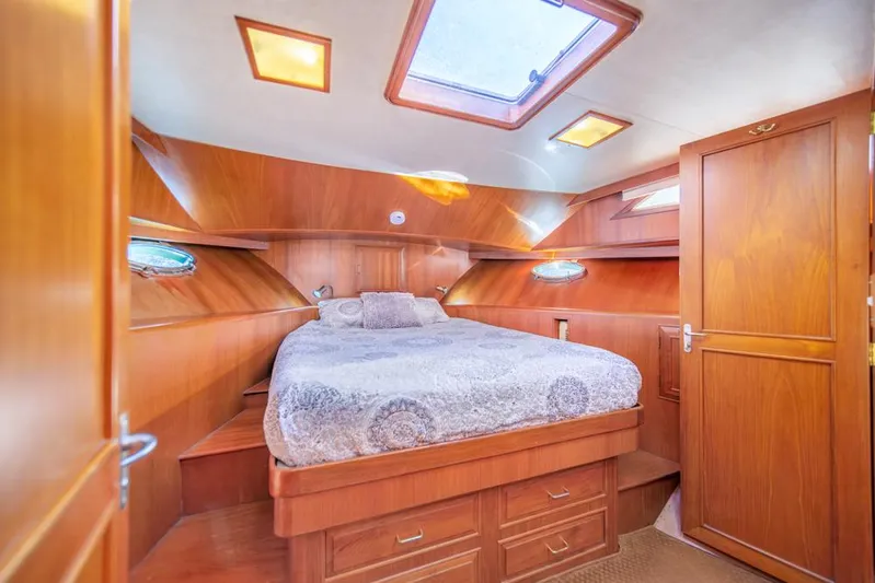 Take Chances Yacht Photos Pics Luxurious 1986 Ocean Alexander Cockpit M/Y cabin with wood paneling and cozy bed.