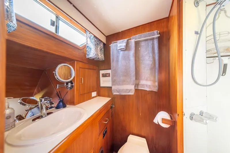 Take Chances Yacht Photos Pics 1986 Ocean Alexander Cockpit M/Y bathroom with wood accents and modern fixtures.