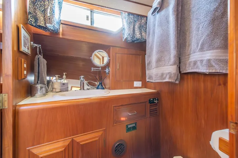 Take Chances Yacht Photos Pics Luxurious 1986 Ocean Alexander Cockpit M/Y bathroom with wood cabinetry and modern fixtures.