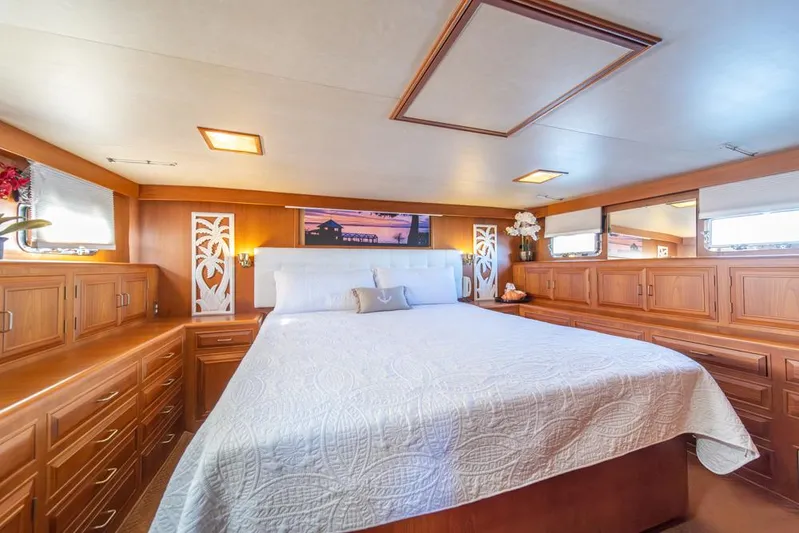 Take Chances Yacht Photos Pics Luxurious 1986 Ocean Alexander Cockpit M/Y bedroom with elegant wood cabinetry and cozy bedding.