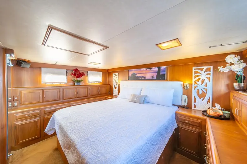 Take Chances Yacht Photos Pics Luxurious bedroom in 1986 Ocean Alexander Cockpit M/Y yacht with elegant wood paneling.