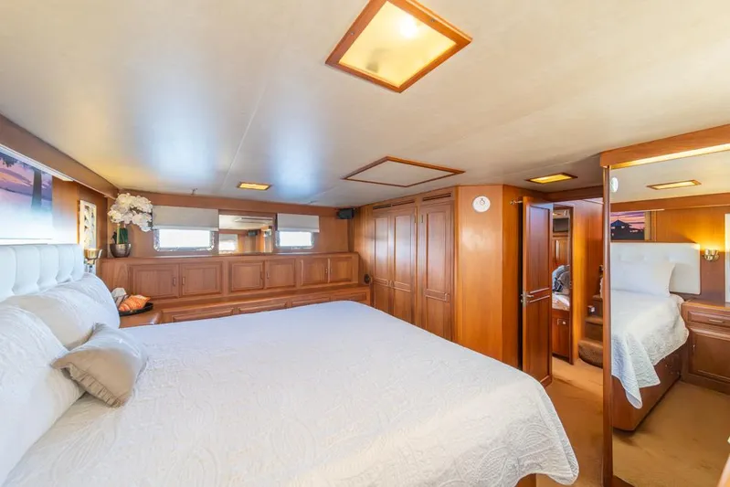 Take Chances Yacht Photos Pics Luxurious 1986 Ocean Alexander Cockpit M/Y bedroom with elegant wood paneling and plush bedding.