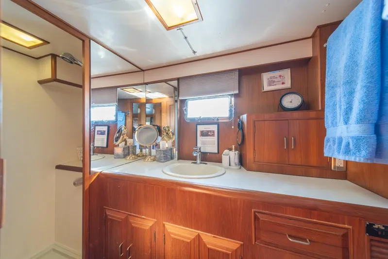 Take Chances Yacht Photos Pics 1986 Ocean Alexander Cockpit M/Y bathroom with wooden cabinetry and modern fixtures.