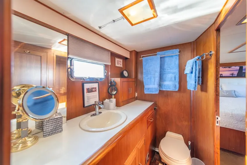 Take Chances Yacht Photos Pics Luxurious 1986 Ocean Alexander Cockpit M/Y bathroom with wood accents and modern amenities.