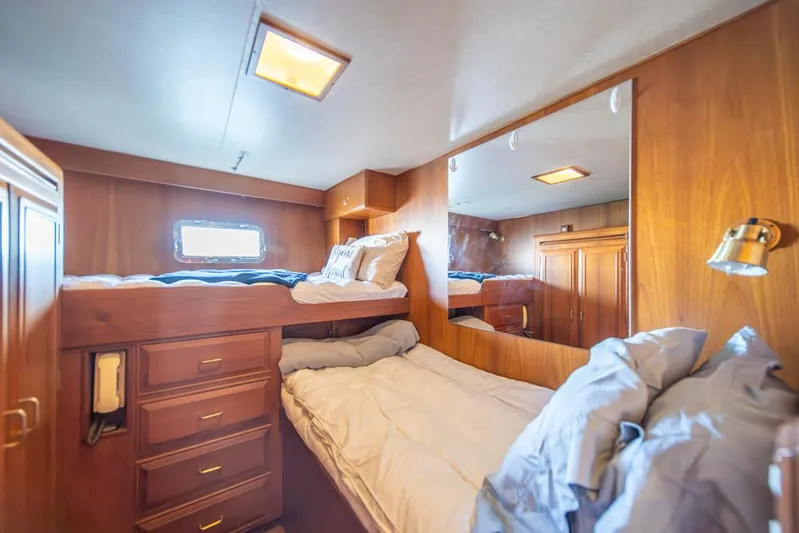 Take Chances Yacht Photos Pics Cozy cabin interior of 1986 Ocean Alexander Cockpit M/Y with wooden furnishings and bunk beds.